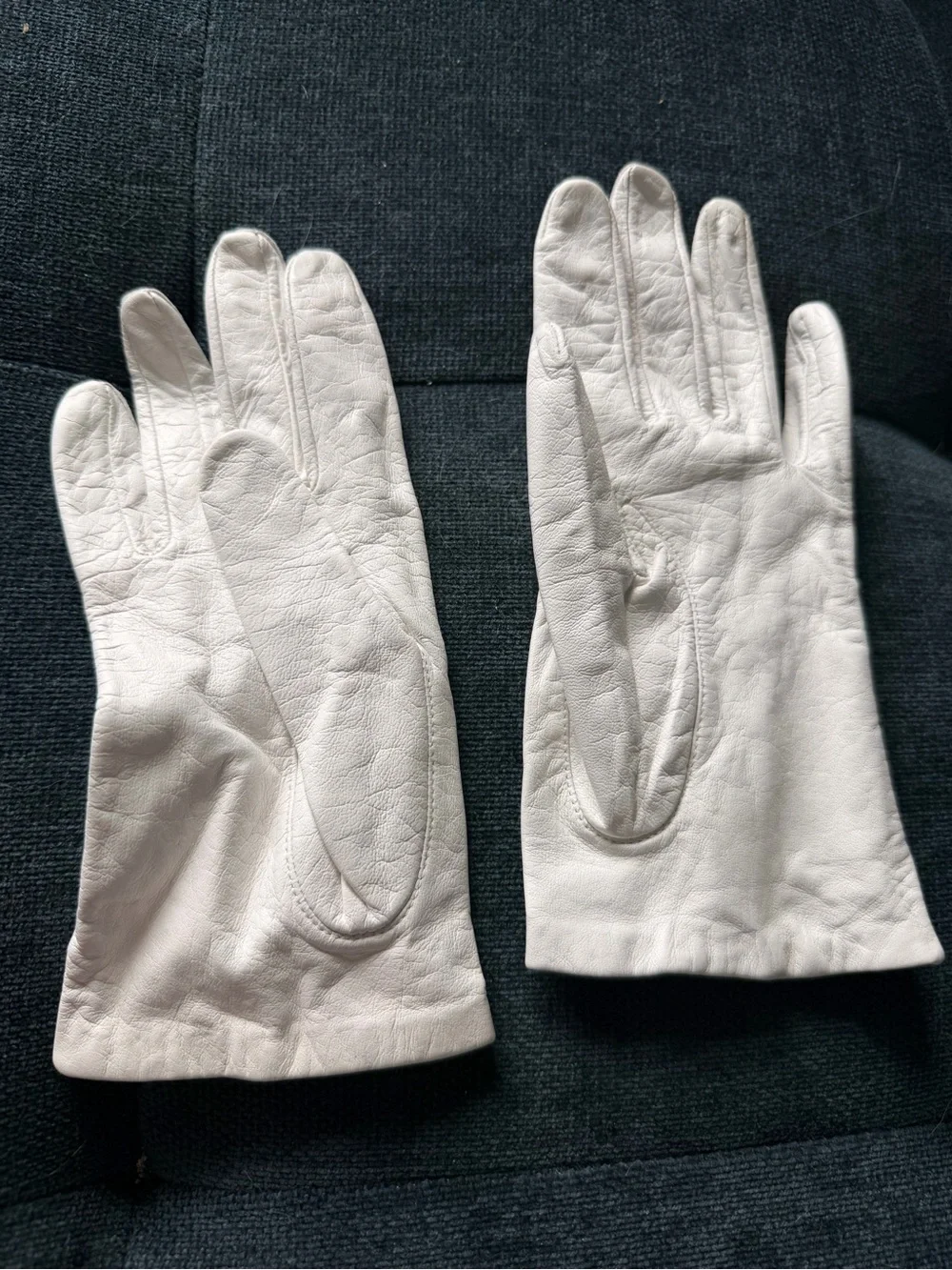 Classic Women’s White Leather Gloves. Brand is Miss Ari’s.
